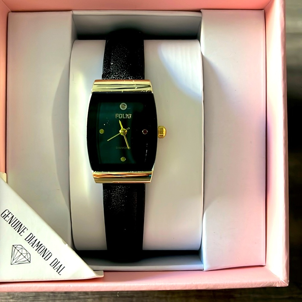 Women’s watch with black band and genuine diamond dial. Never removed from box.
